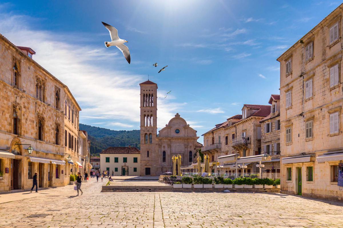 Main,Square,In,Old,Medieval,Town,Hvar,With,Seagull's,Flying