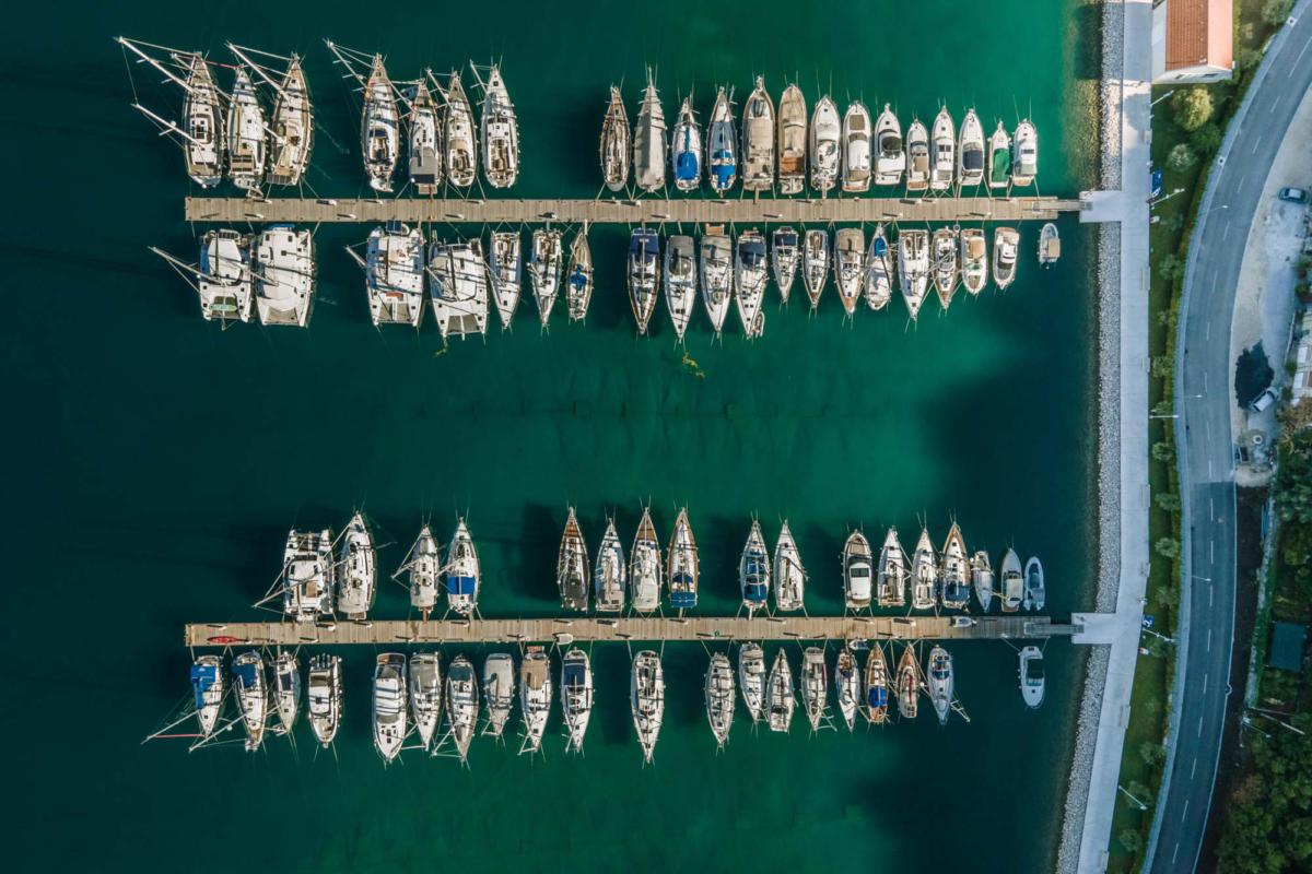 Aerial,View,Of,Sailing,Boats,Docked,Along,The,Pier,In